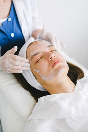 Woman in a beauty salon with face cream